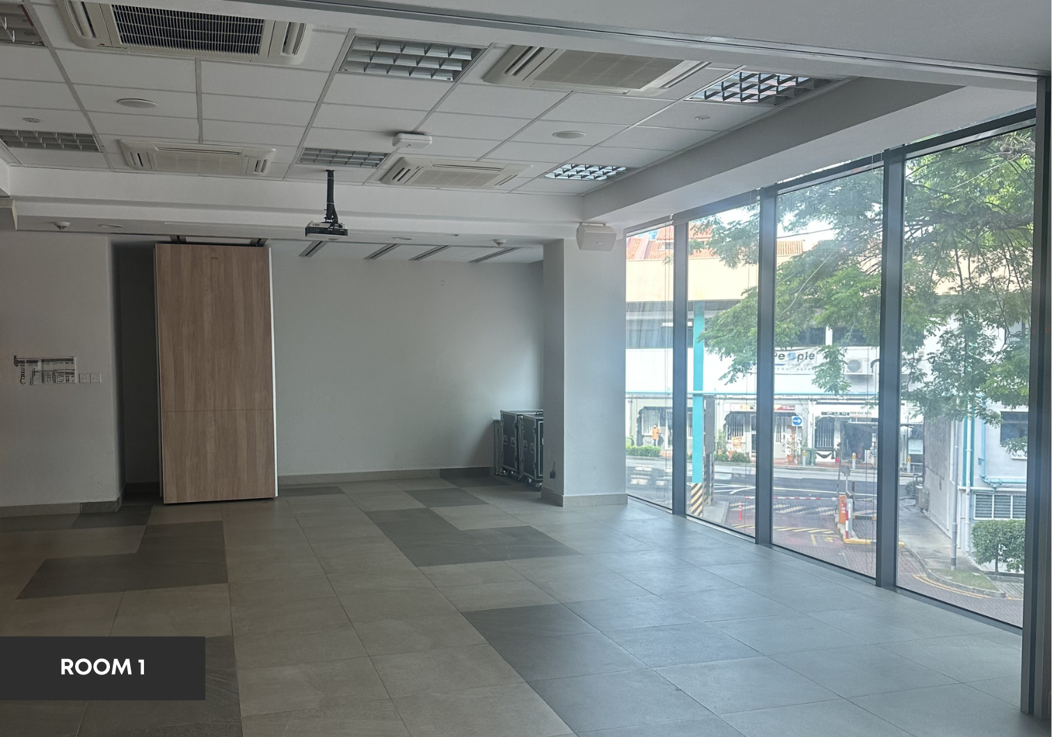 Pre-function room with floor-to-ceiling windows and projector.